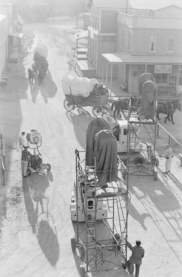 People traveling by wagons in a scene from a film at Universal studio lot in Hollywood, 1963.