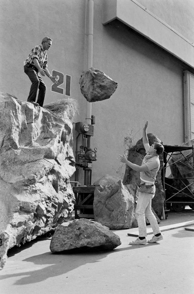 Prop men tossed a rubber rock at the Universal studio lot in Hollywood, 1963.