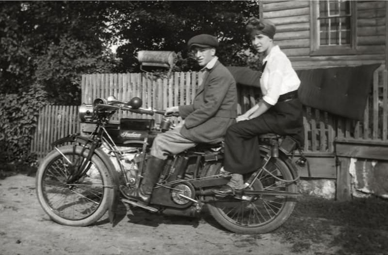 Two sitting on an Indian motorcycle, 1910s