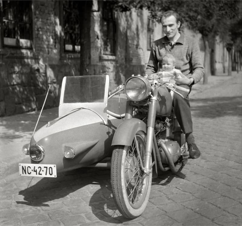 Father holding his child on a Pannonia motorcycle and sidecar, somewhere in Hungary, 1950s