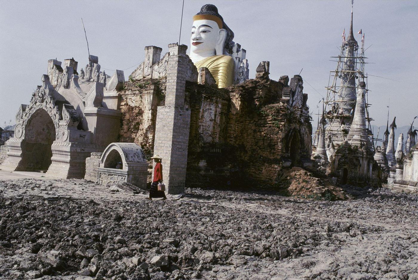 Nyaung Shwe, Myanmar - Woman Passing a Statue of Buddha Near Inle Lake, 1980s