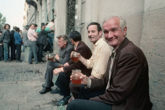 Men drinking beer outside bar in Ukraine, 1991
