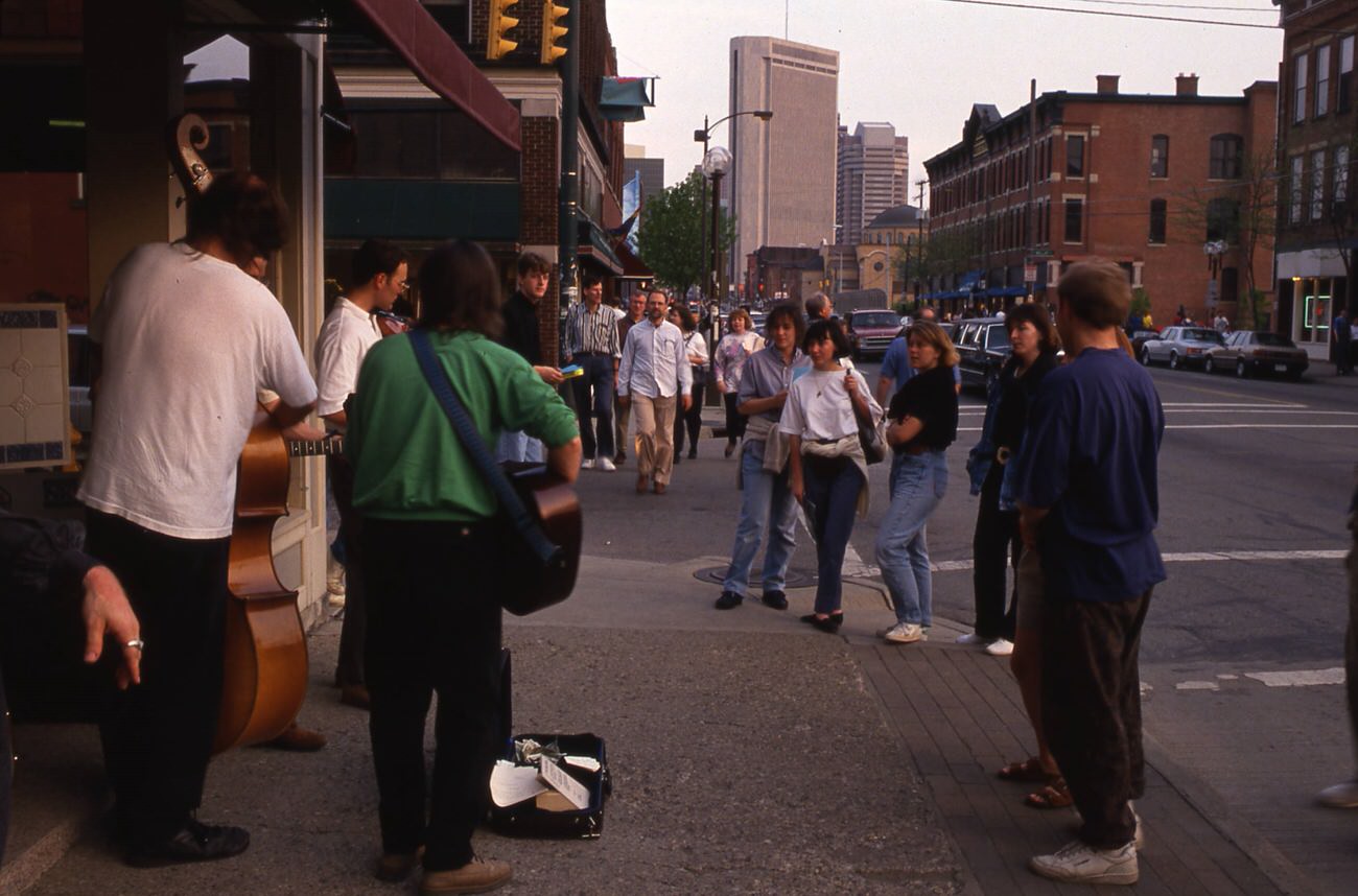 Street musicians on North High Street at Russell Street, entertaining pedestrians during a Gallery Hop Saturday, 1993.