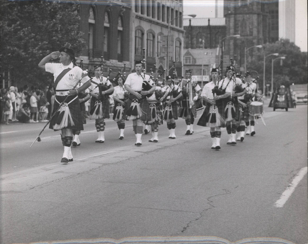 Capital City Pipes and Drums with Drum Major David Breese in a parade in downtown Columbus, 1970s