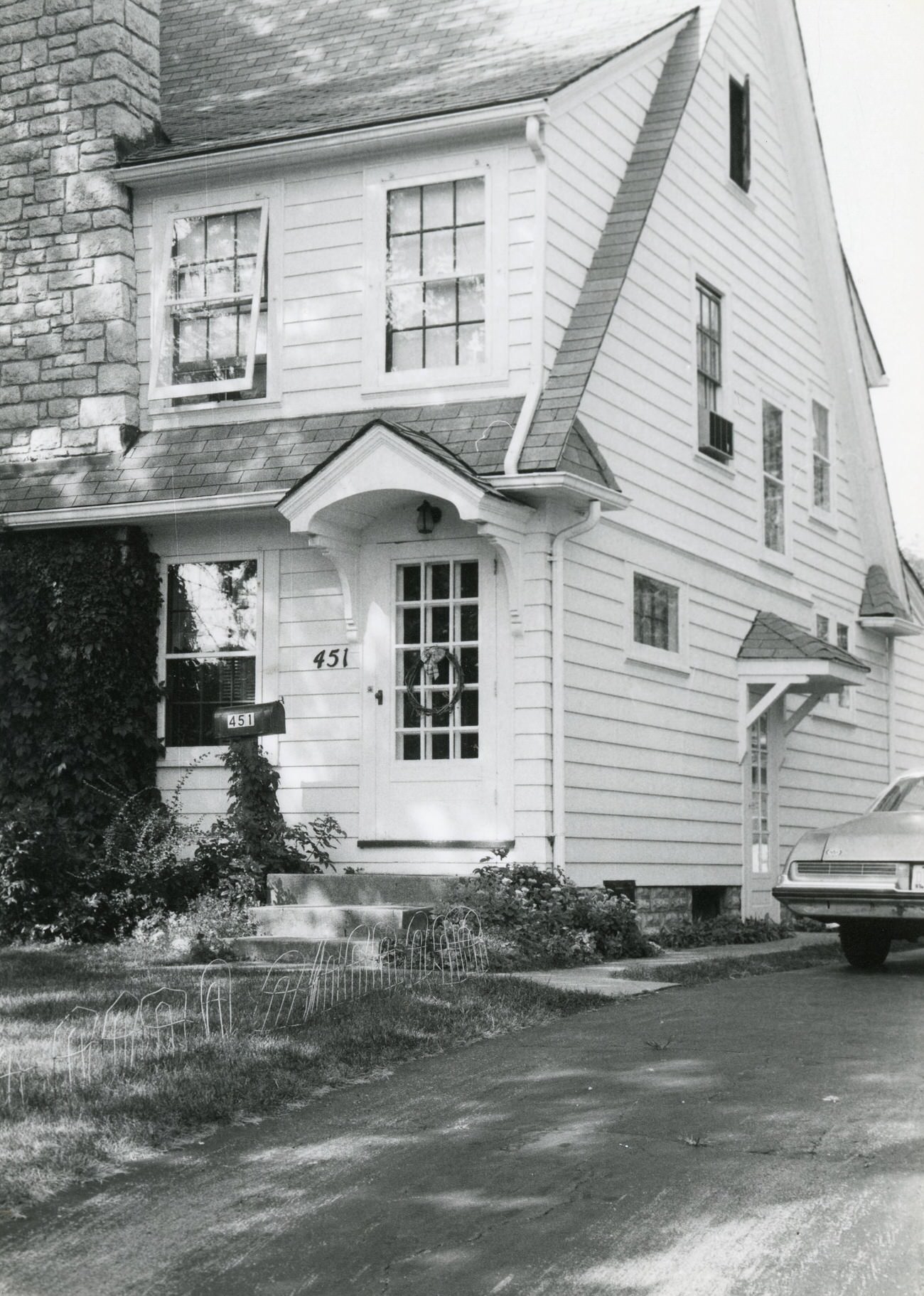 Front door and right side of 451 S. Guernsey Ave. with a car in the driveway, Hilltop, 1980s.