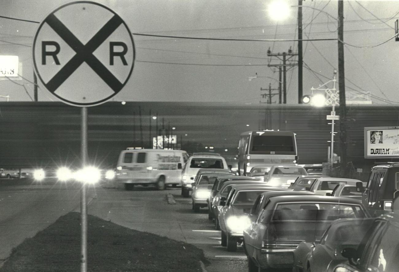 Evening rush hour train crossing Westheimer Road inside Loop 610, Houston, Texas.