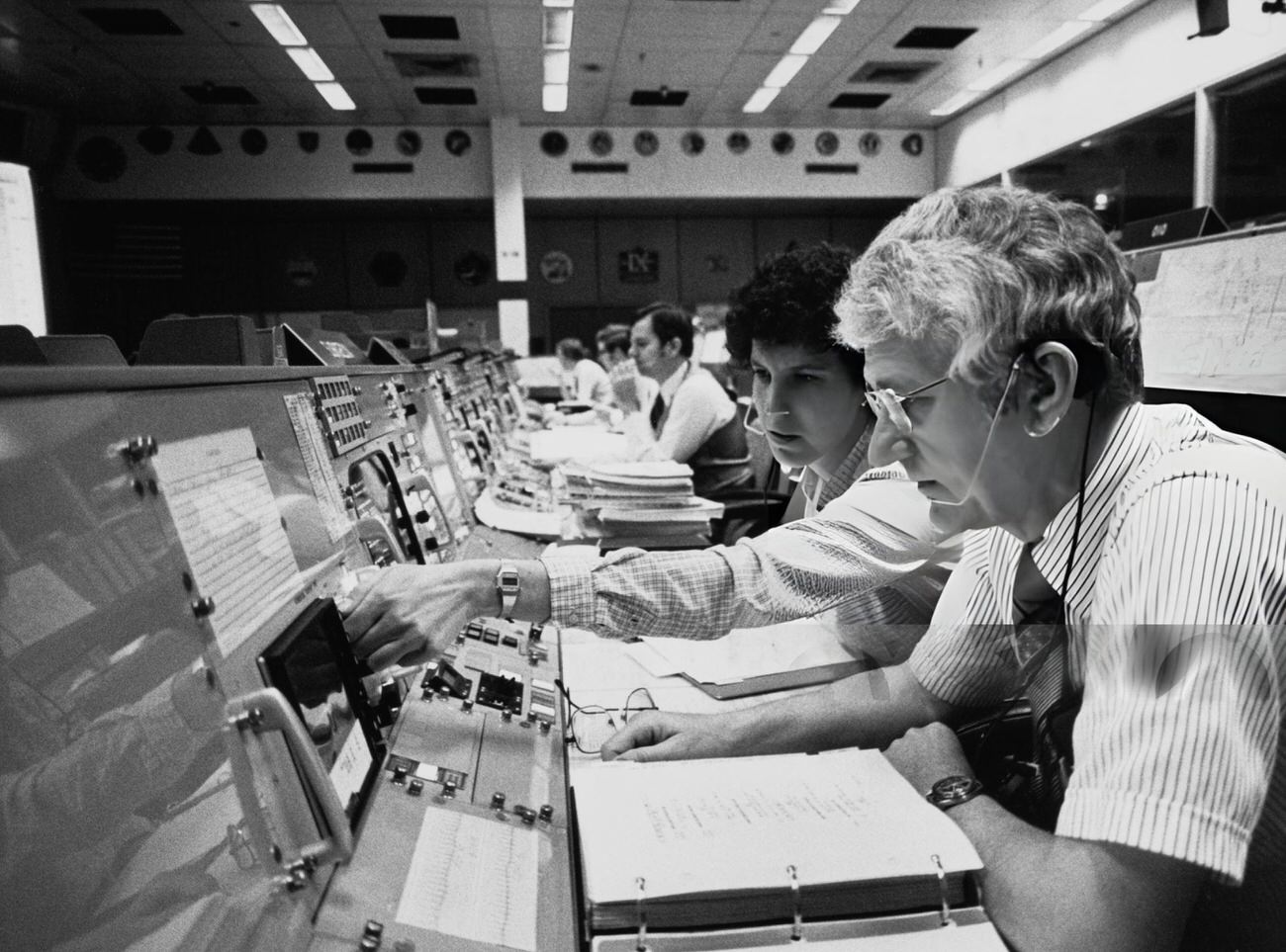 Astronauts Henry W. Hartsfield and Ellen S. Baker in mission control during STS-3, Houston, Texas, 1982.