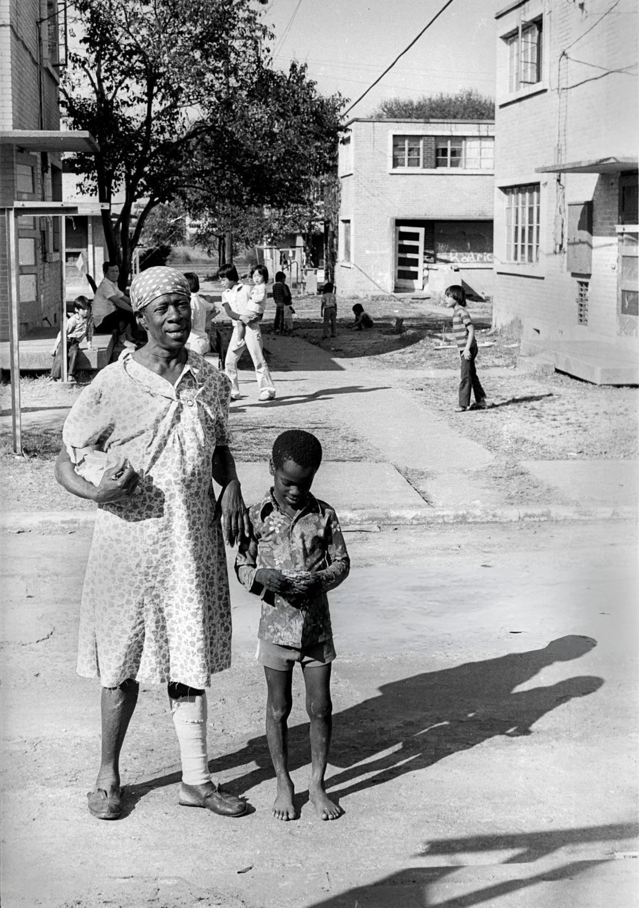 A grandmother and her grandson crossing a street, Houston, Texas, 1983.