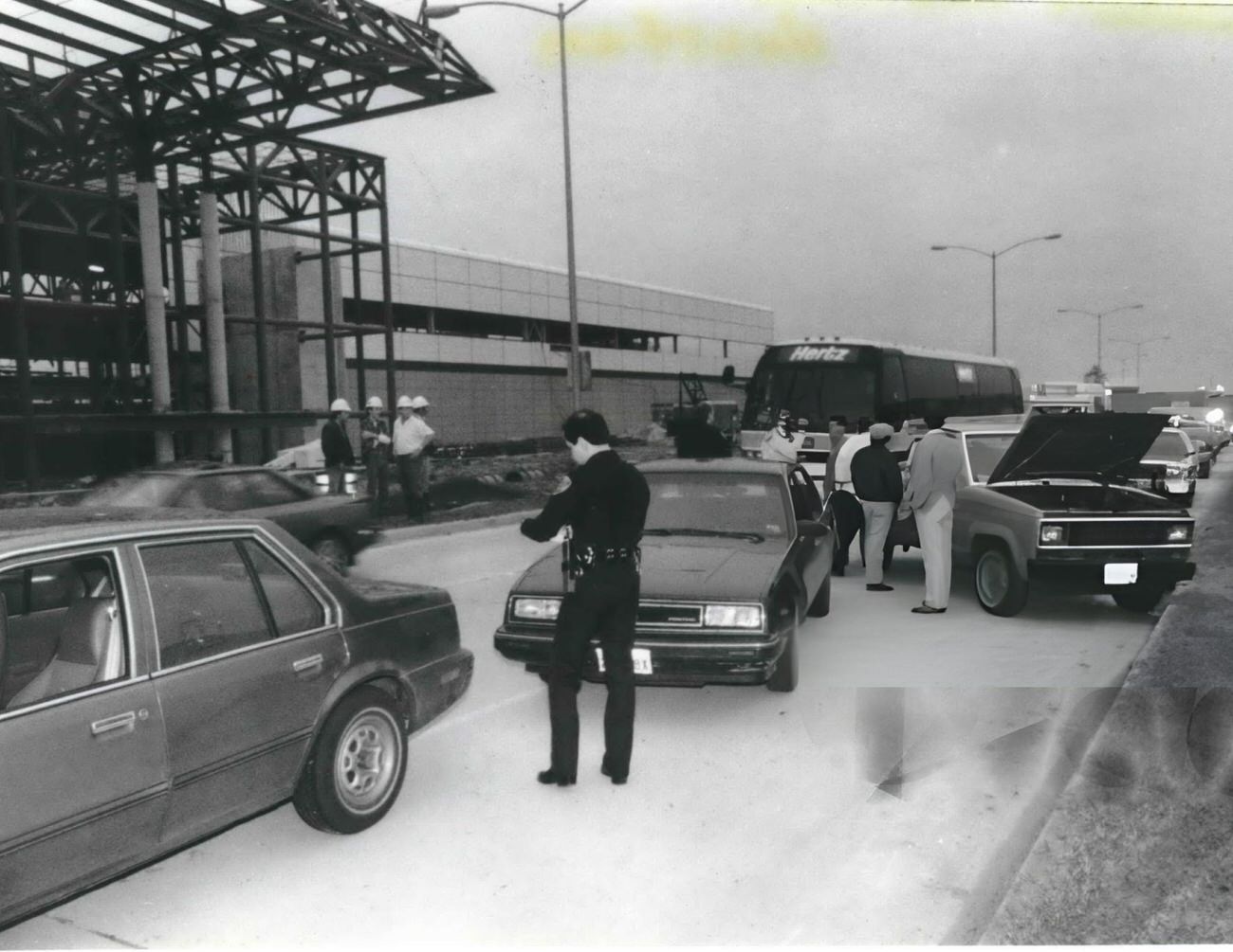 An airport police officer writes tickets for vehicles blocking traffic at Houston International Airport's Terminal C during a dispute with Eastern Airlines, Houston, Texas.