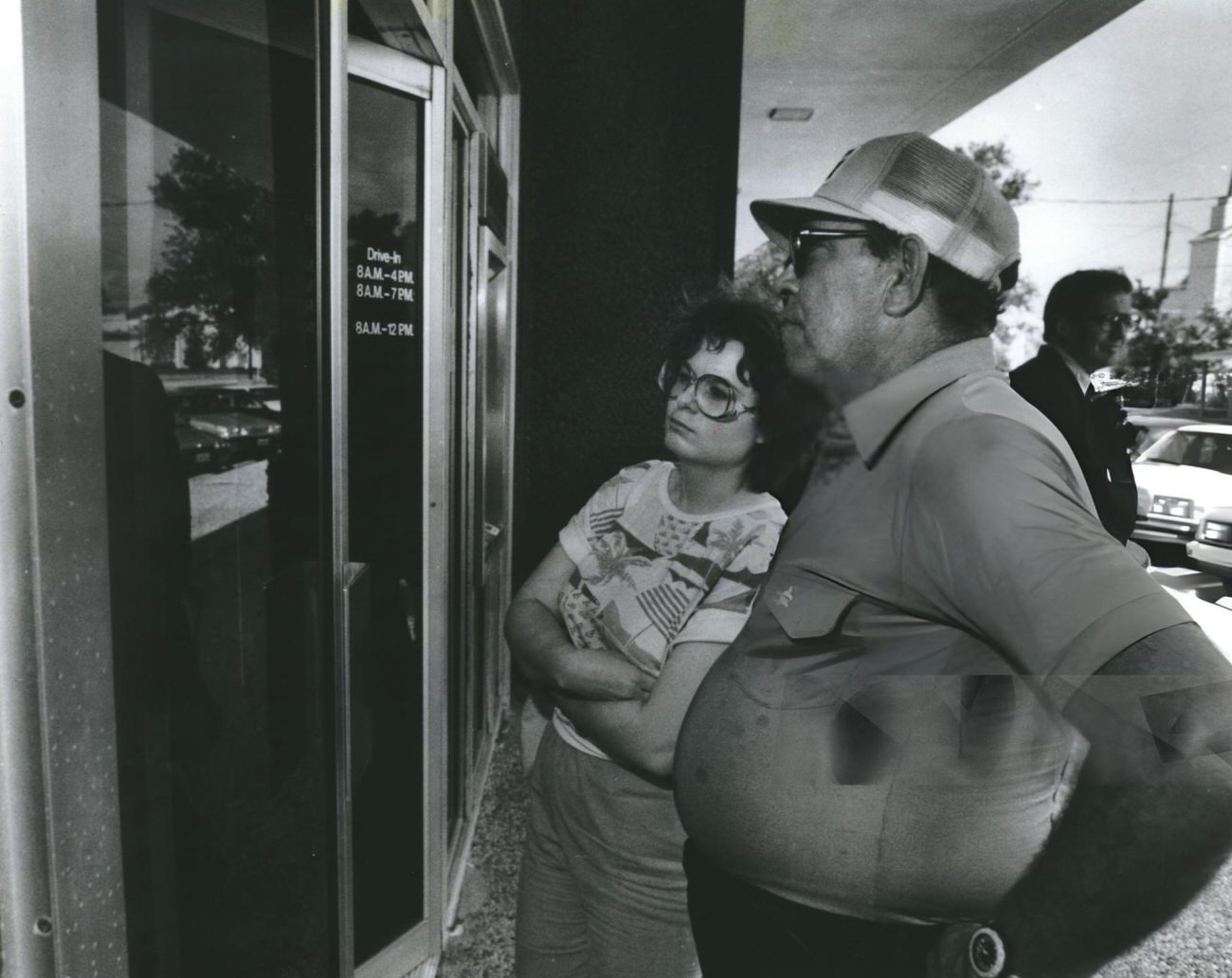 Ruby Peek and Carlos Vivo read the insolvency notice on the door of Katy National Bank, Houston, 1980s