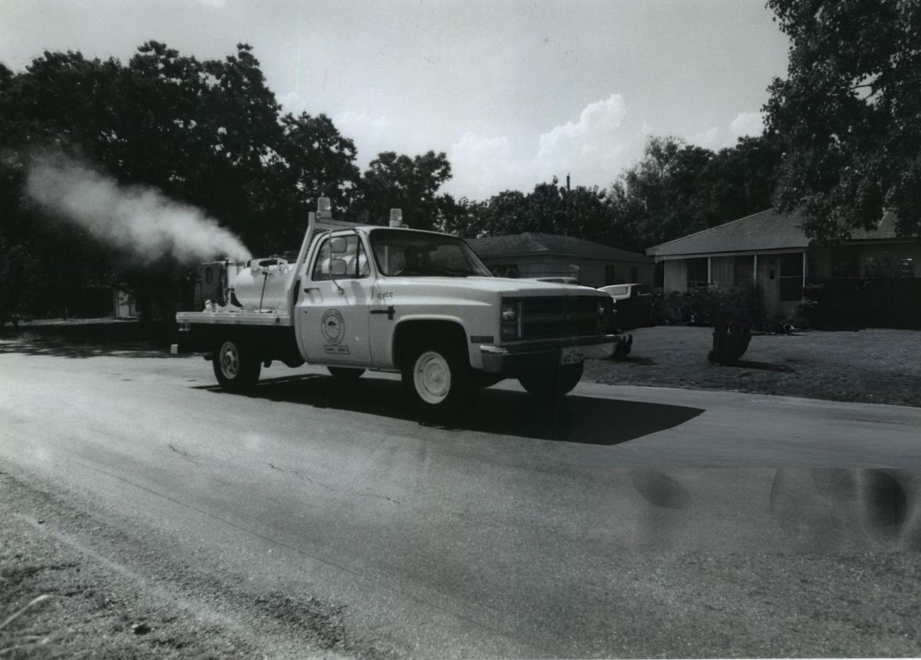 Sidney Pennie sprays insecticide in a Houston suburb following floods, as part of the Harris County Mosquito Control District's efforts.