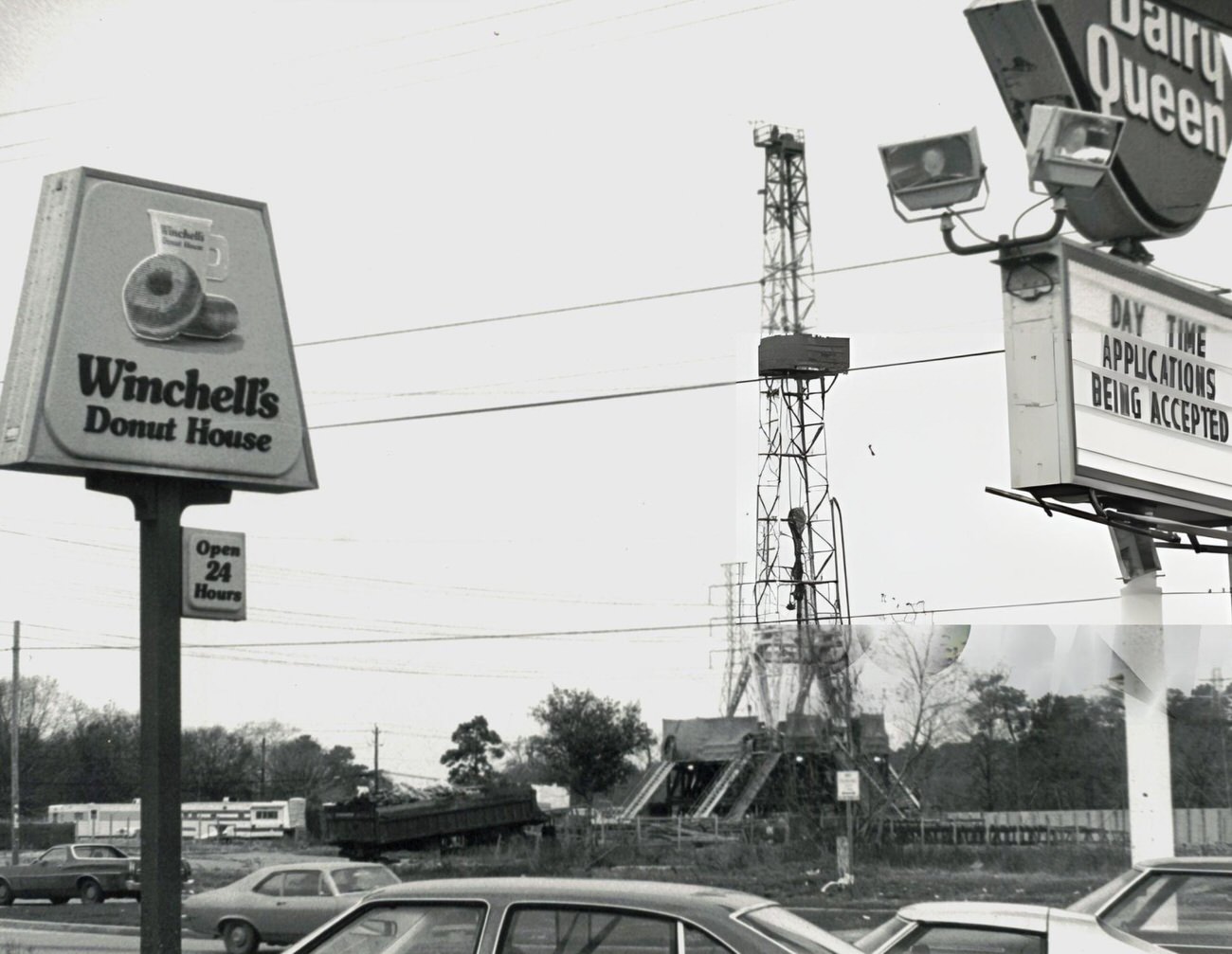 A drilling rig towers above traffic and shops on 20th Street, Houston, Texas, February 7.