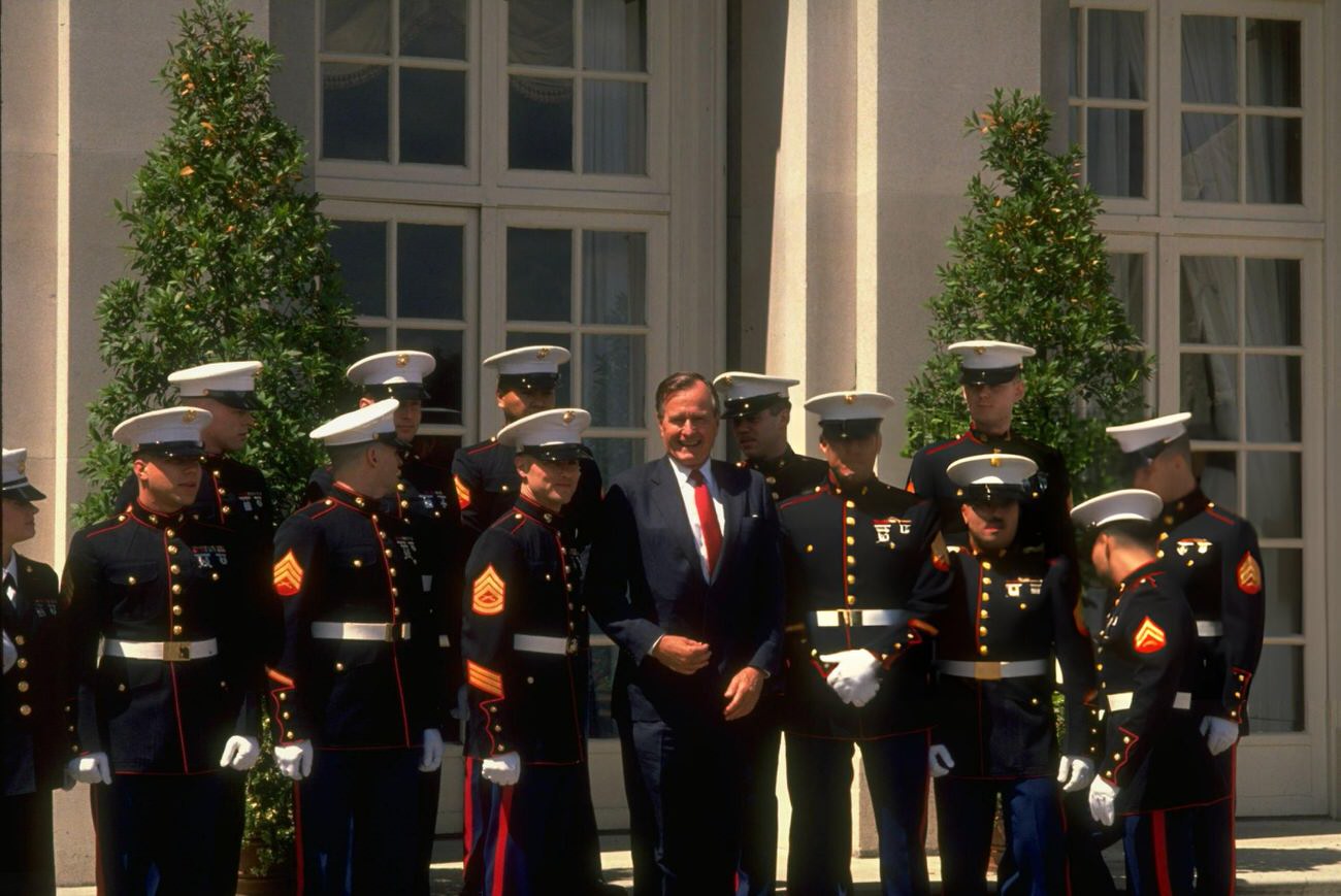 President George H.W. Bush is flanked by his white-gloved honor guard marines during the Houston Economic Summit, Texas.
