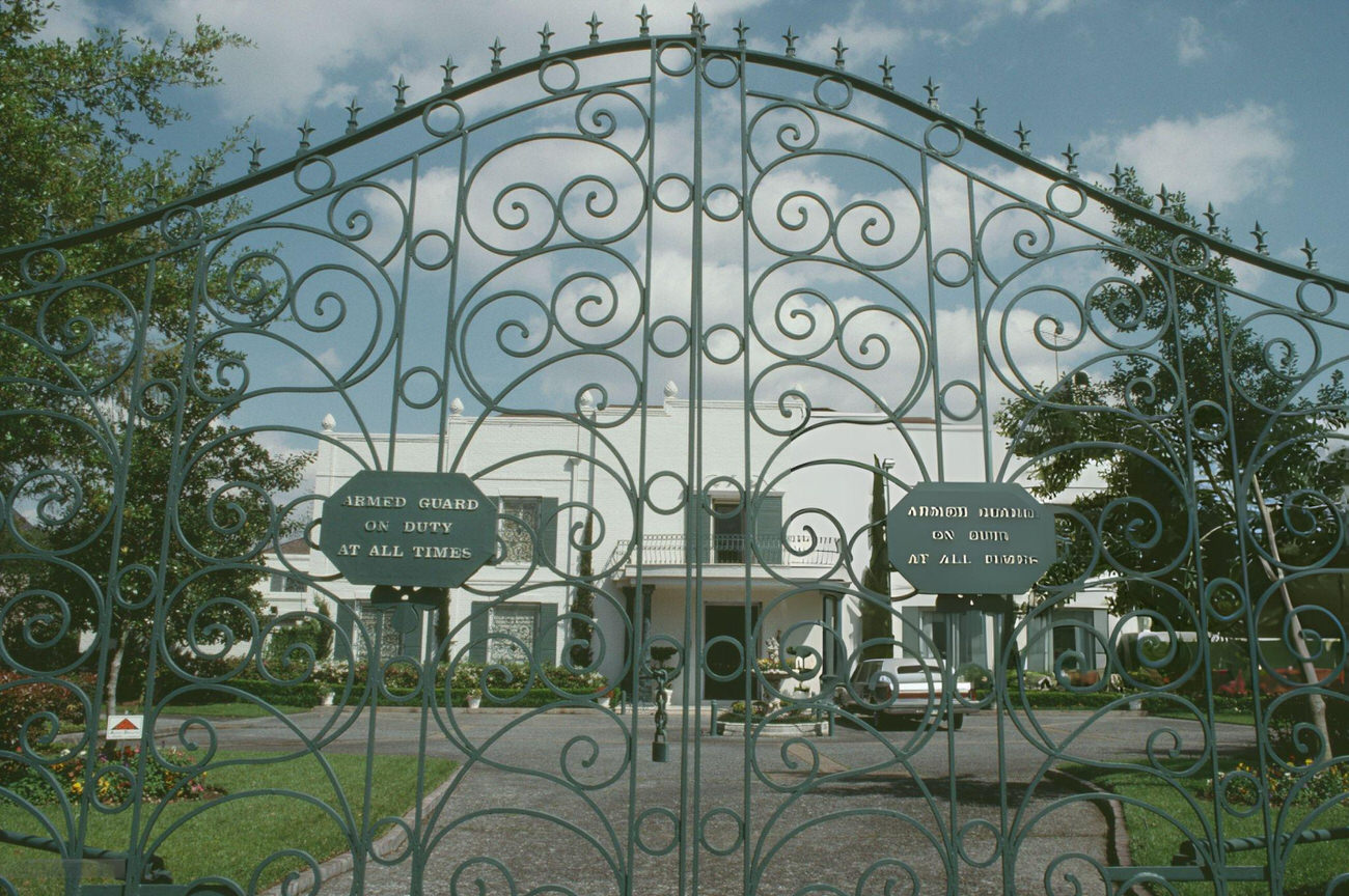 The gate of a private residential building in April 1992 symbolizes the exclusivity and privacy valued in Houston's residential architecture, Texas.