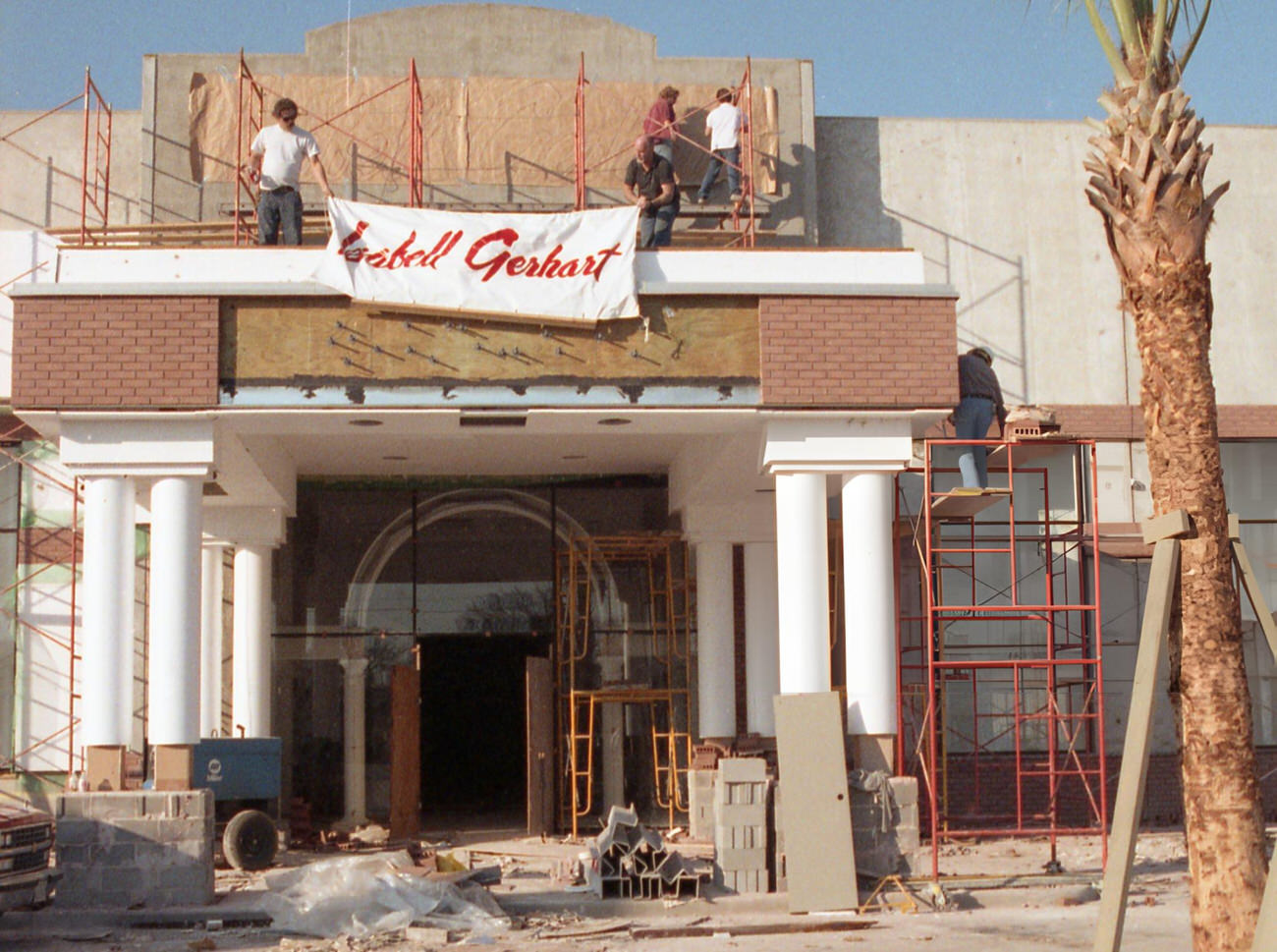 Workers install a banner at the Isabell Gerhart store in River Oaks Plaza, marking the upscale clothier's relocation from the Galleria, Houston, Texas, 1991.