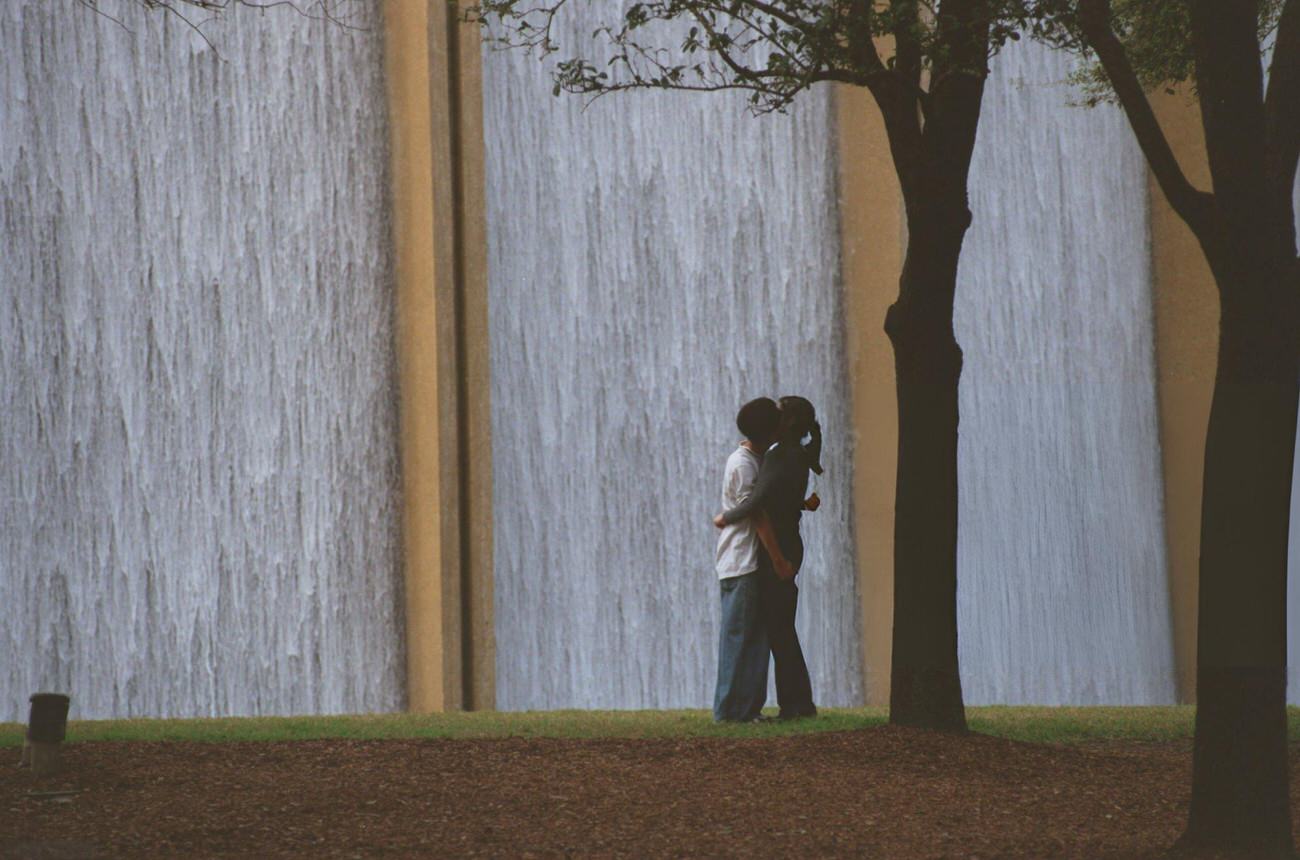 Yvonne Lee and Michael Nguyen by the Transco Tower water wall, Houston, Texas, 1999.