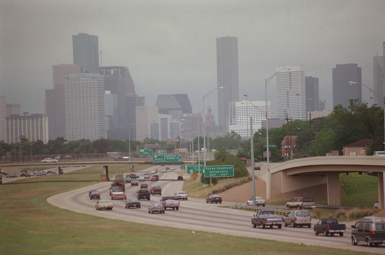 Downtown Houston skyline obscured by smog, viewed from North MacGregor Way bridge, Houston, Texas.