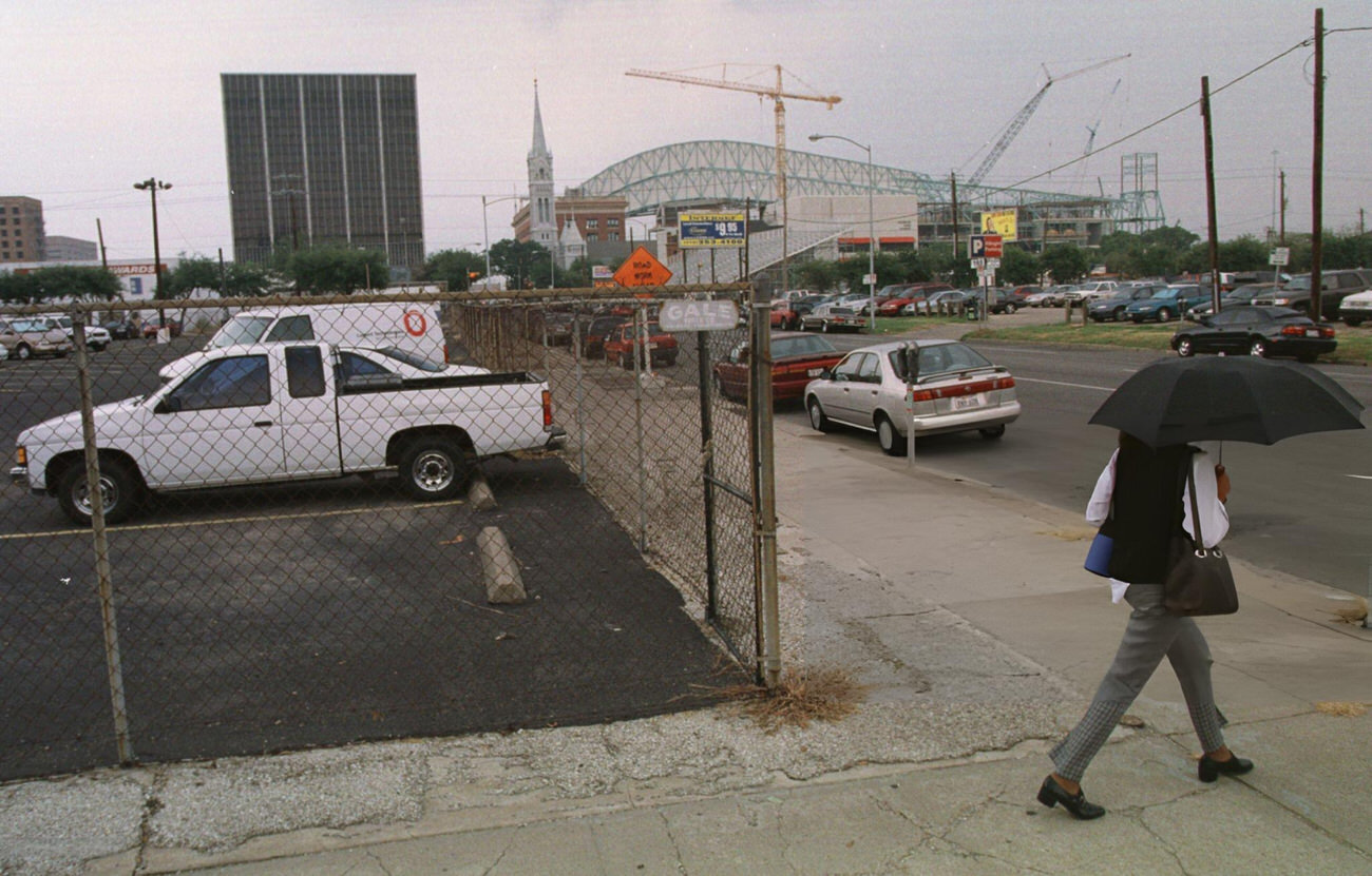 Pedestrian walks past a future basketball/hockey arena site downtown, Houston, Texas, 1999.
