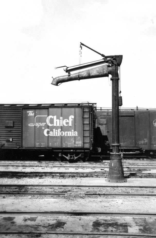 Pump at train station with "The Super Chief California" train car, 1950s
