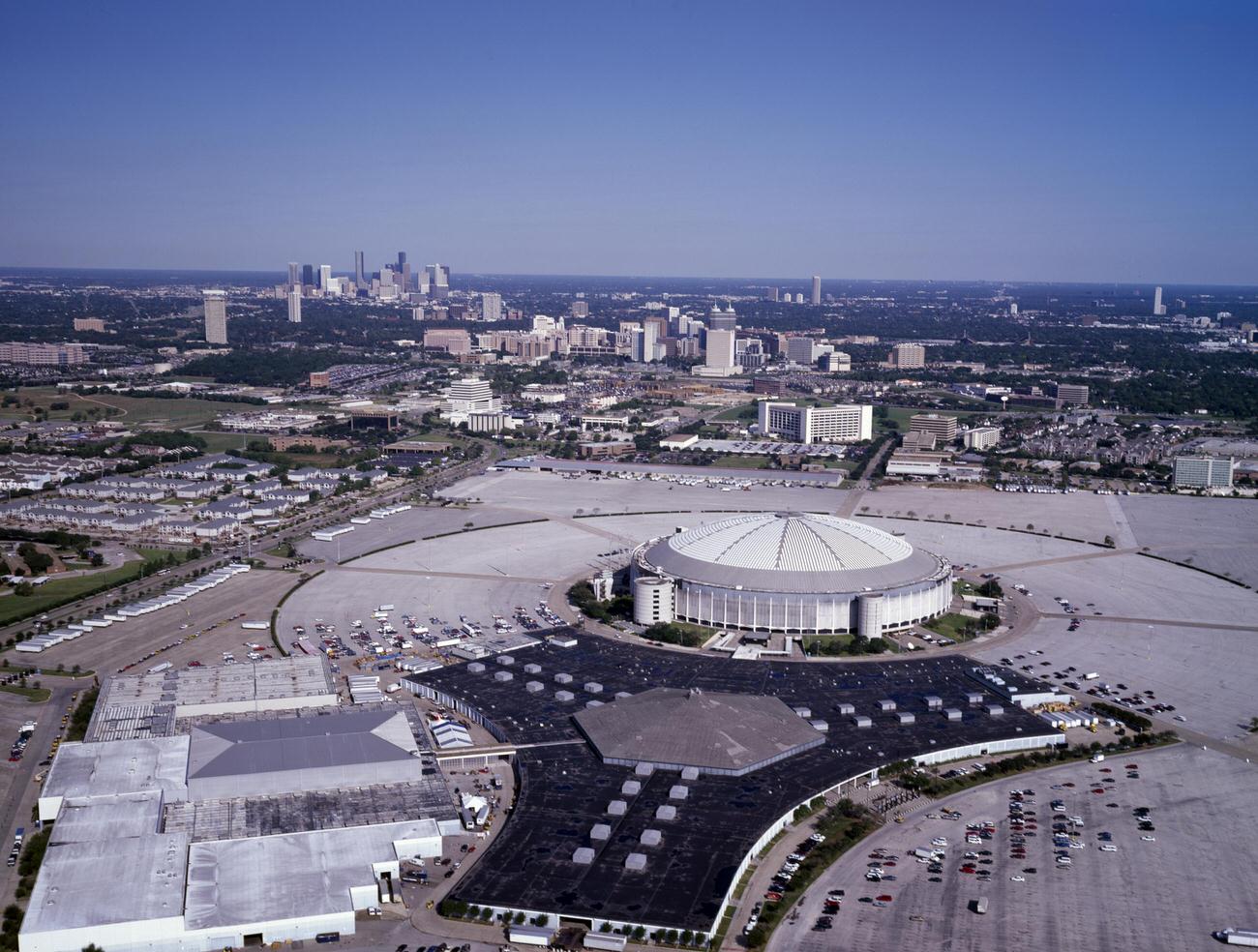 Aerial view of the Houston Astrodome, with downtown in the distance, 1990s