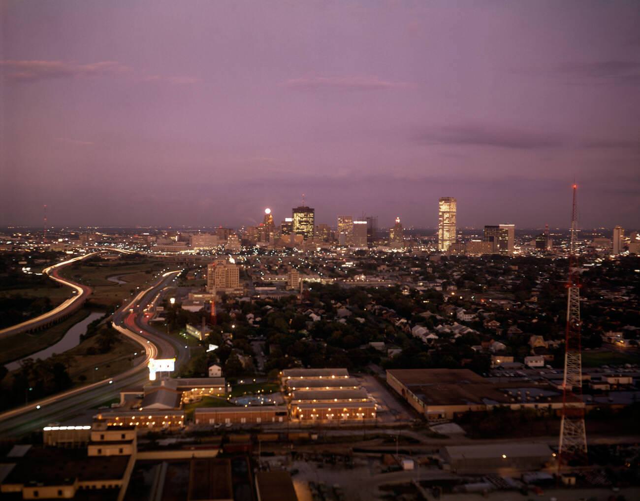 Elevated view of Houston's skyline at twilight, showcasing urban sprawl, 1960.