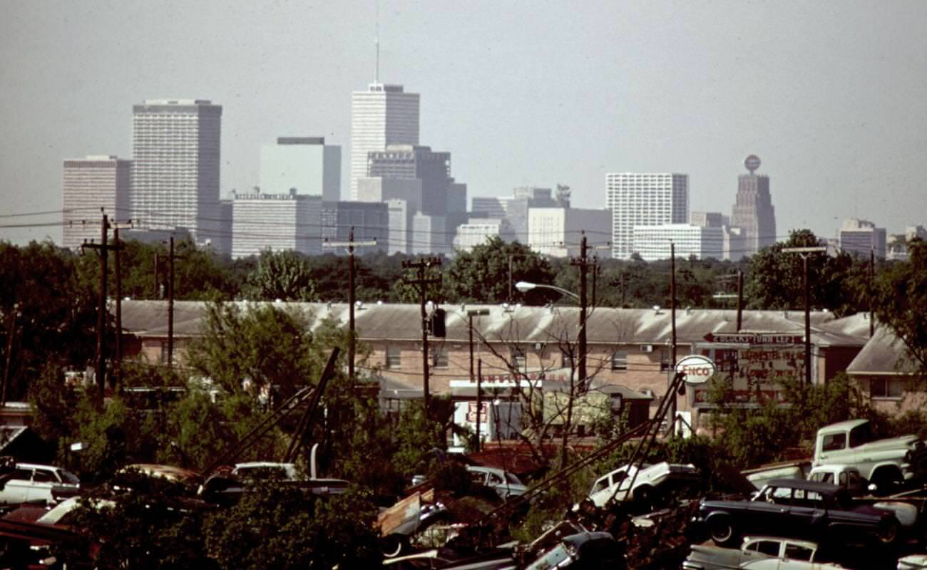 Automobile junkyard with the Houston skyline in the background, 1973.