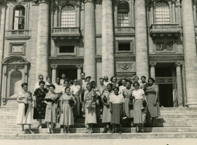 Jessie L. Lott and others outside building with pillars, 1950s