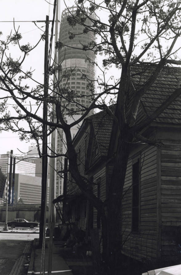 View of Houston from street with wood buildings, 1960s