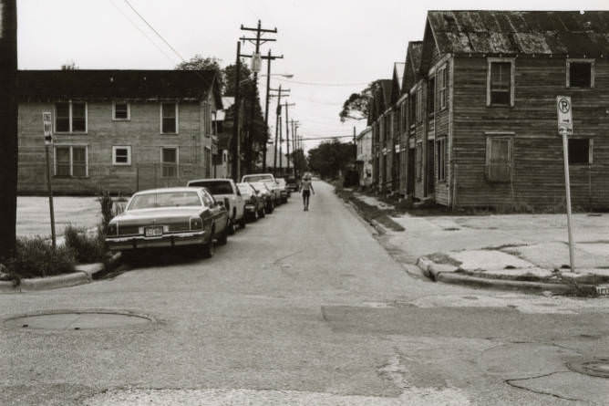 Person walking down street, 1970s