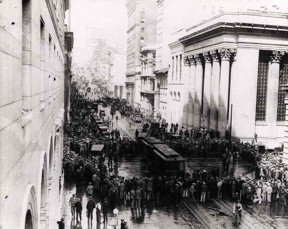 Group of people gathering around a cable car on Montgomery and California Street in 1926.