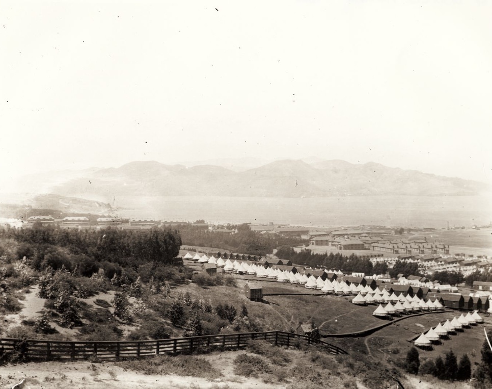 View of the Presidio, army barracks and tents, and San Francisco Bay in the background in 1898.