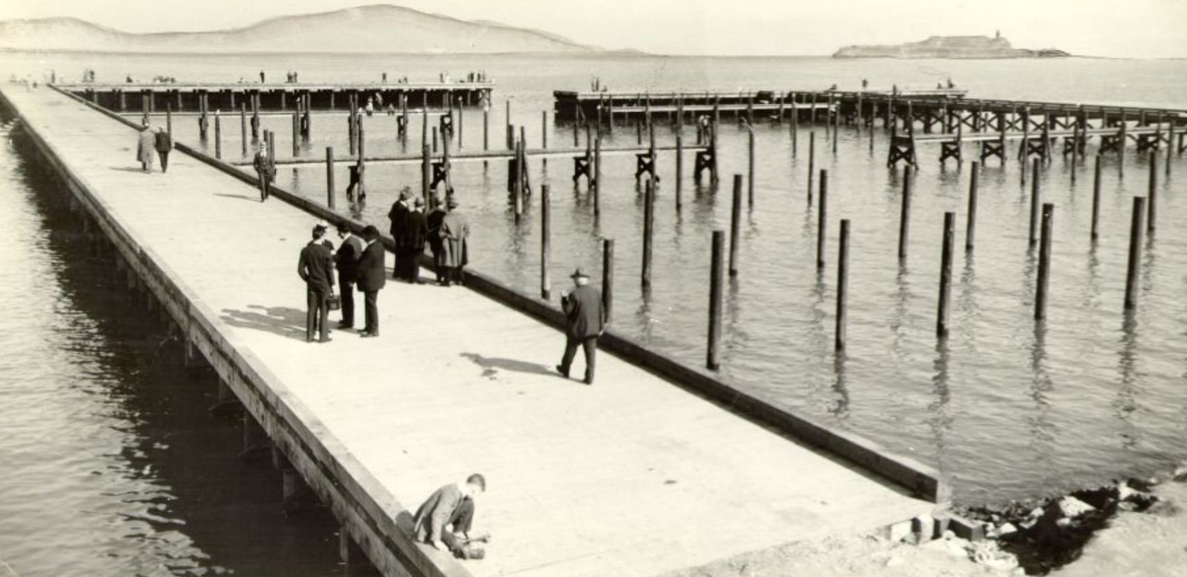 People walking along the Marina pier, 1933