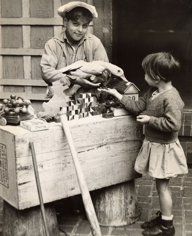 Community Chest girl and boy at a toy stand, 1934