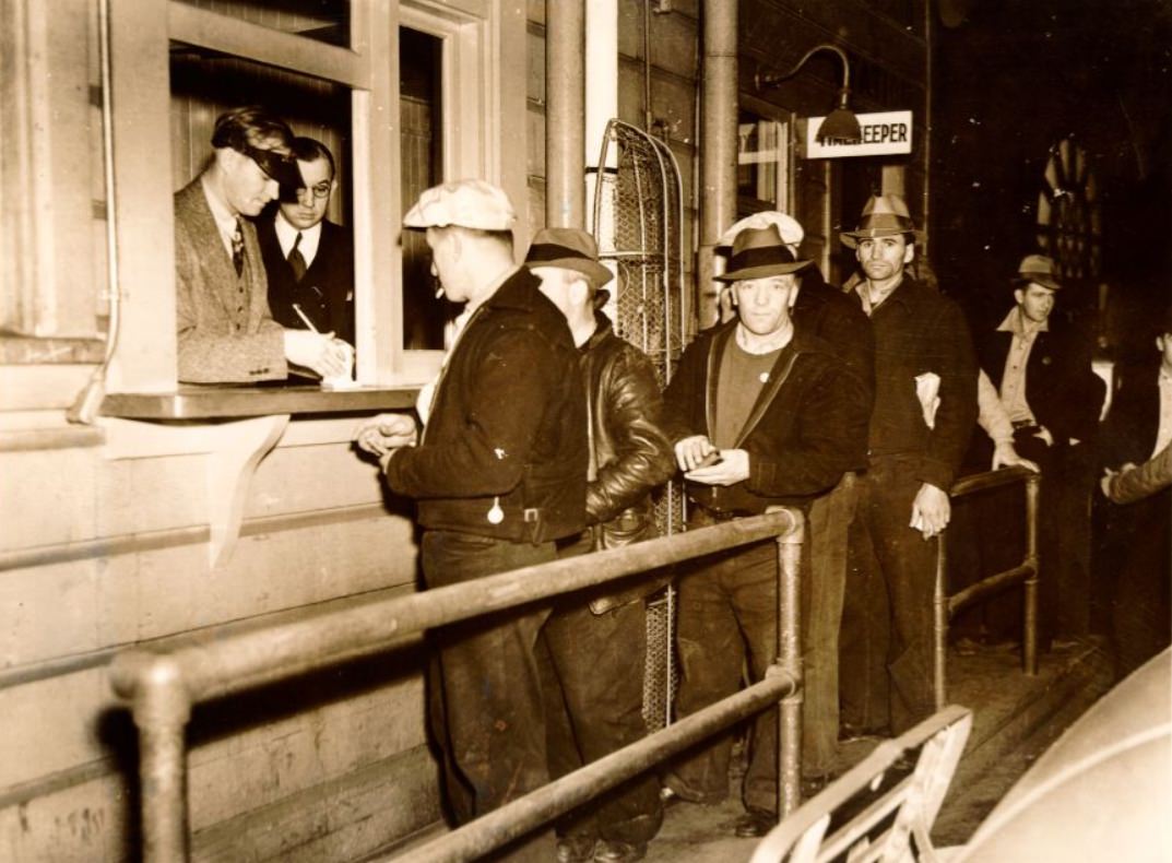 Men waiting in line at the waterfront, 1938