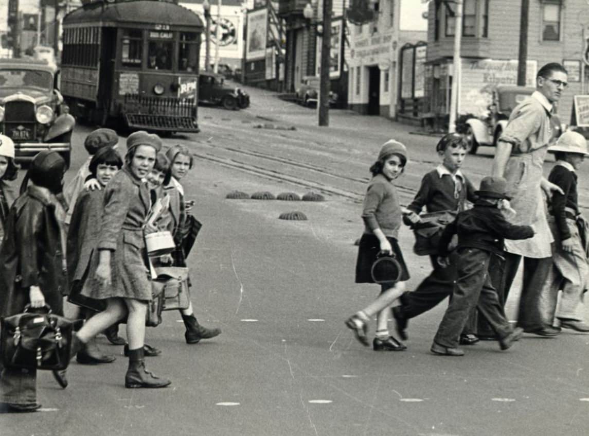 Children being safely escorted across Geary and Cook Street, 1937