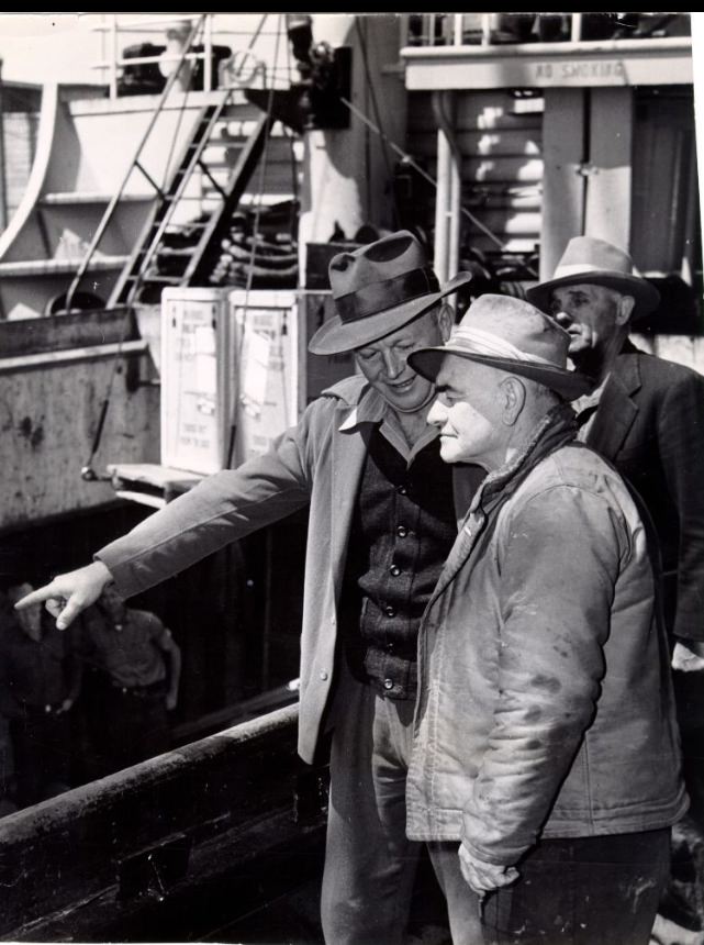Chester (Pop) Hardister discusses loading operations with Bill Huschens, 1950