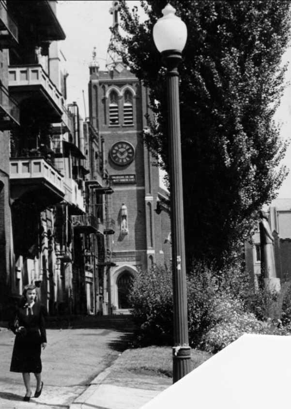 Sydney Ayers walking past Old St. Mary's Church, 1947