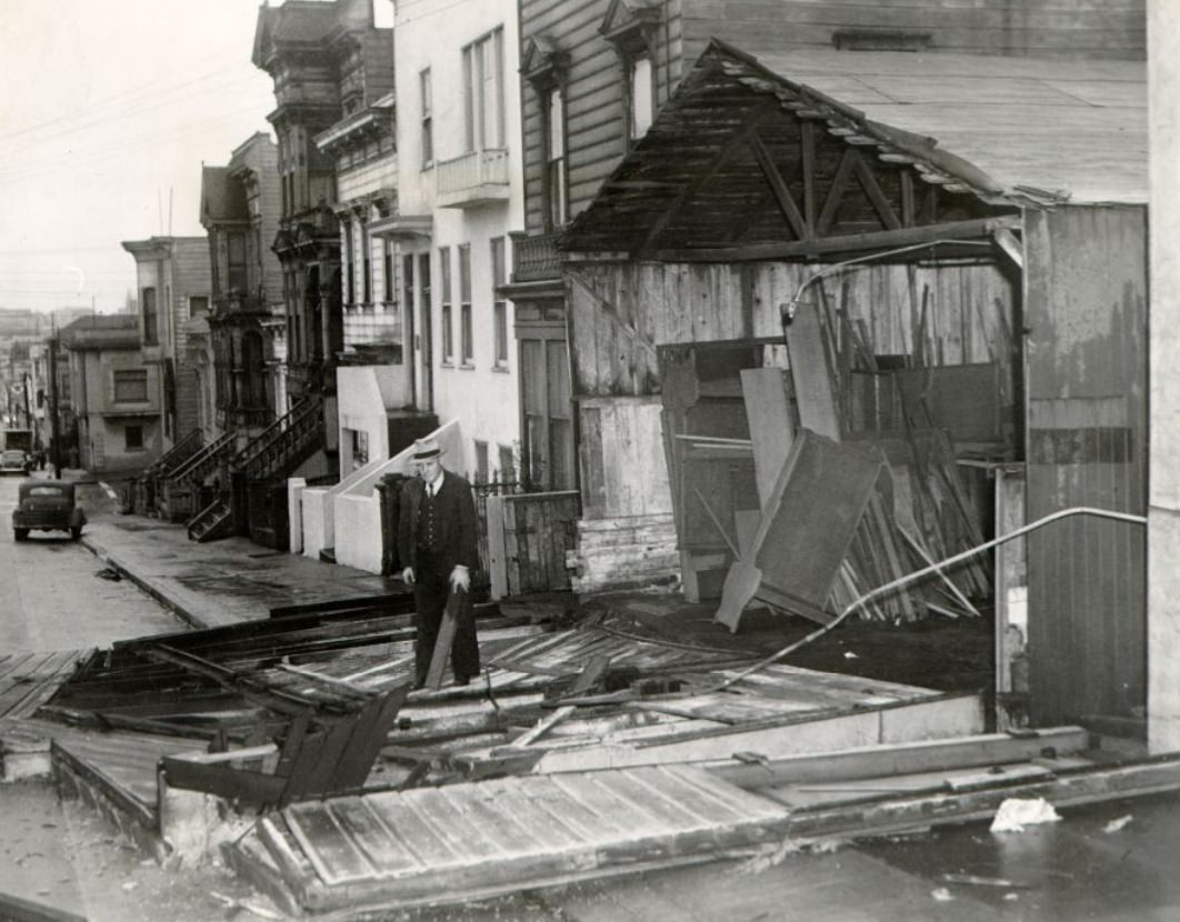Al Simon in front of his wind-damaged cabinet shop at 2555 Post Street, 1943