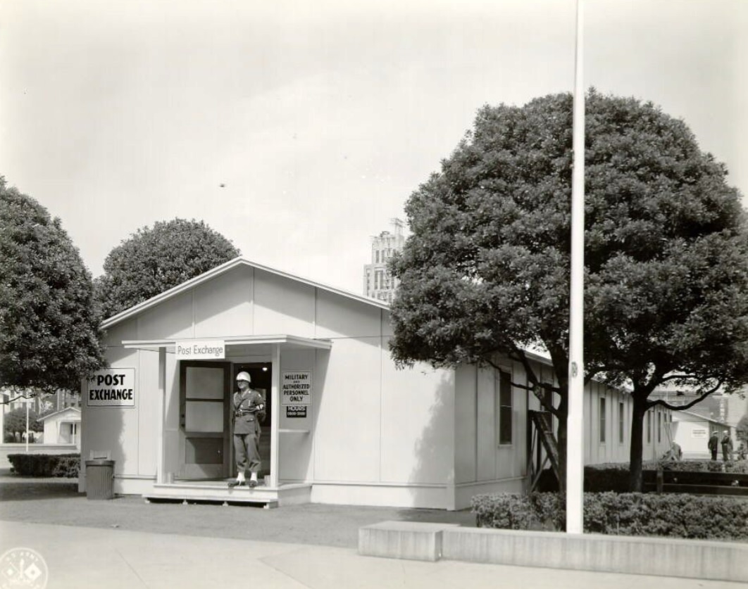 Soldier standing outside the Post Exchange, Temporary Barracks, Civic Center Plaza, 1940s