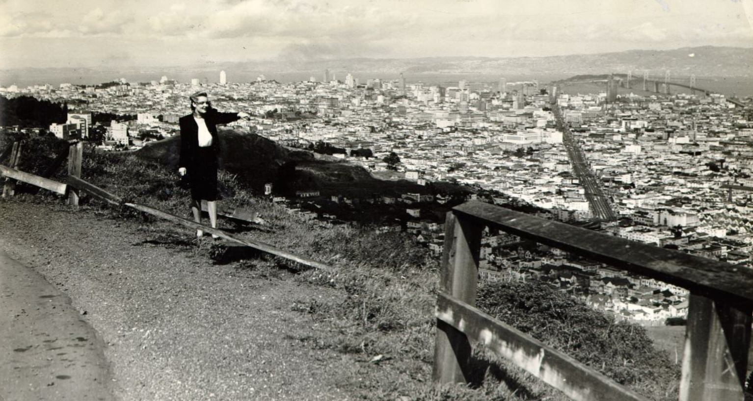 Joan Magnusson near a broken railing along Twin Peaks Boulevard, 1947