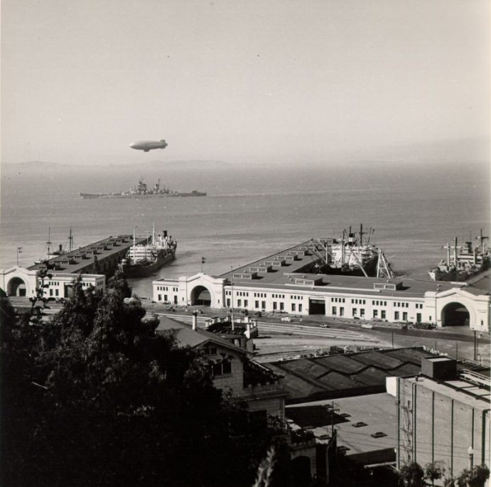 Blimp over a ship off Pier 34 in San Francisco Bay, 1940s