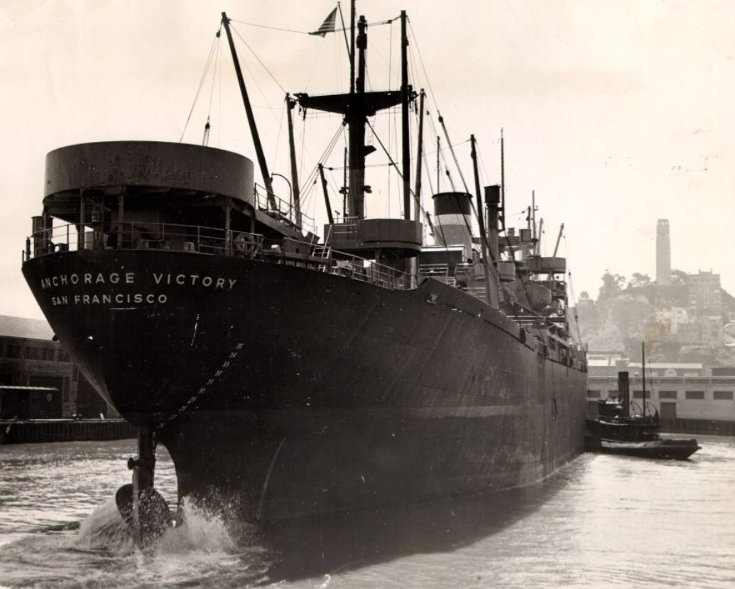 Tug boat pushing the S.S. Anchorage Victory at a San Francisco pier, 1946