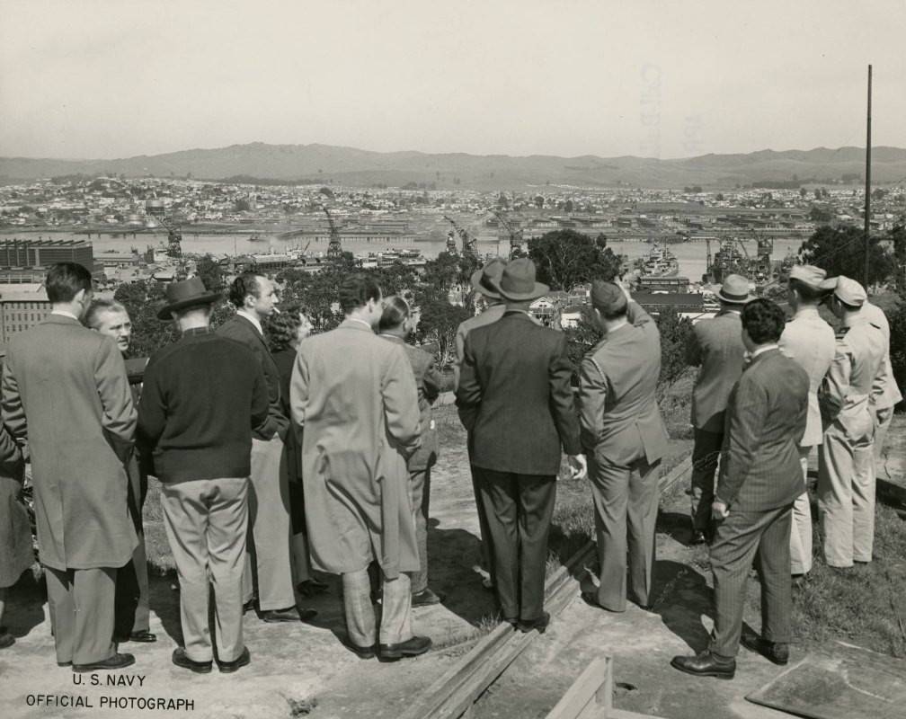 Press members overlooking Hunters Point from a hilltop, 1945