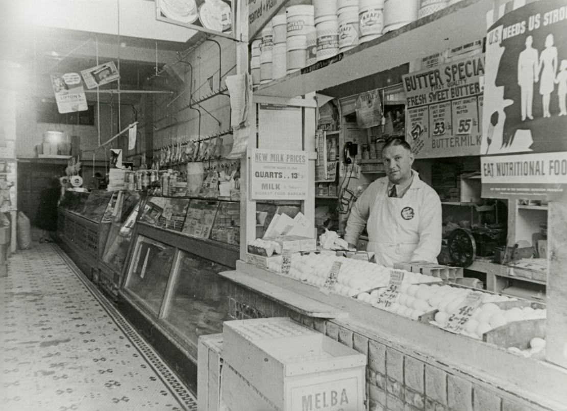 Owner George working at Eagle Market on Fillmore Street, 1940s