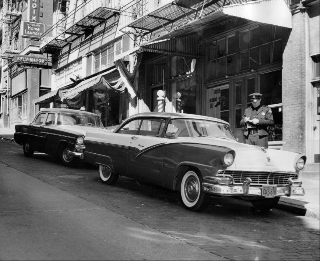 Police officer issuing a parking ticket on Clay Street, 1956.