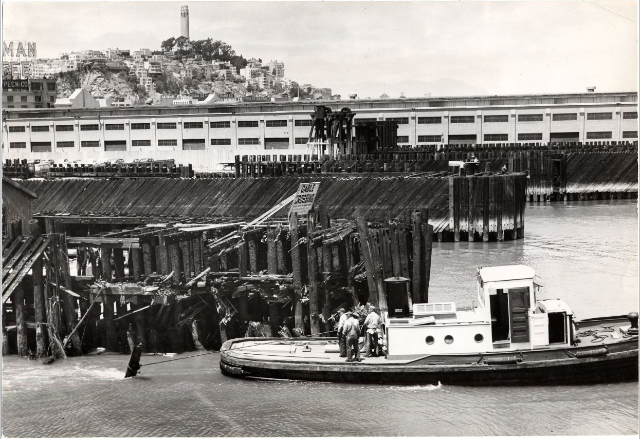Tugboat Gov. Stephens pulling debris from the channel leading to the Southern Pacific pier, 1954.