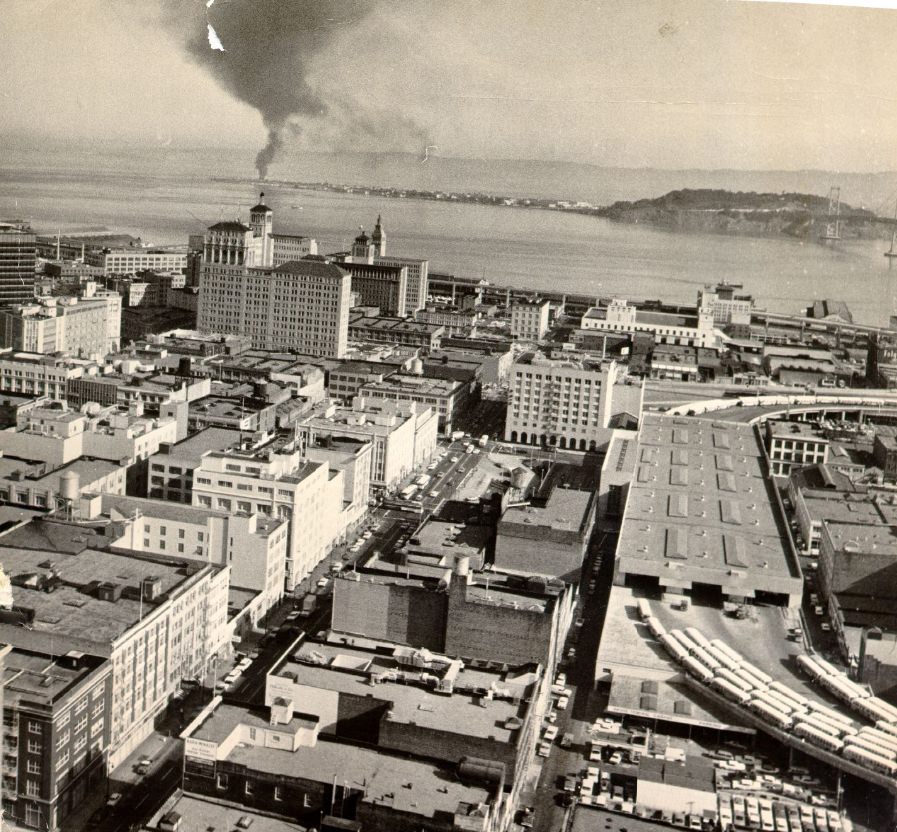 View of downtown San Francisco with Treasure Island and Yerba Buena Island in the distance, 1964.