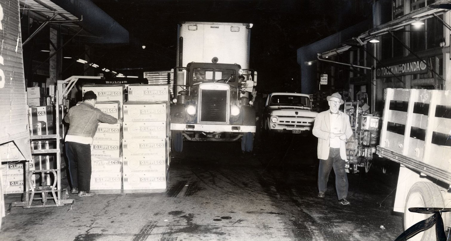 Delivery trucks being unloaded in downtown San Francisco's old produce district, 1960.