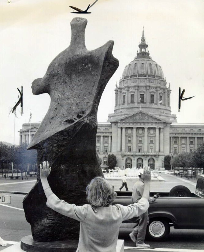 Laurie MacTavish admiring 'Winged Figure' by Henry Moore, Civic Center Plaza, 1963.