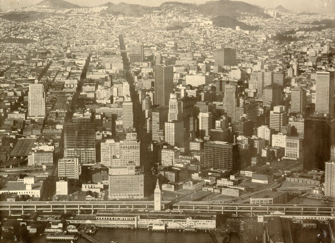 Aerial view of San Francisco from over the bay, looking west up Market Street, 1960s.